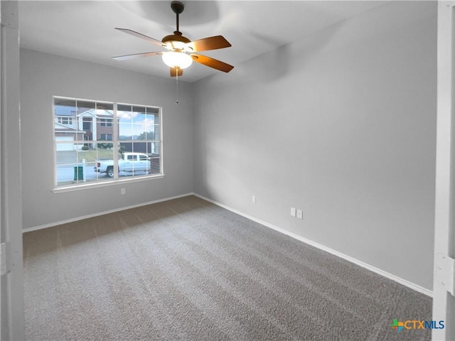 unfurnished room featuring ceiling fan and carpet floors