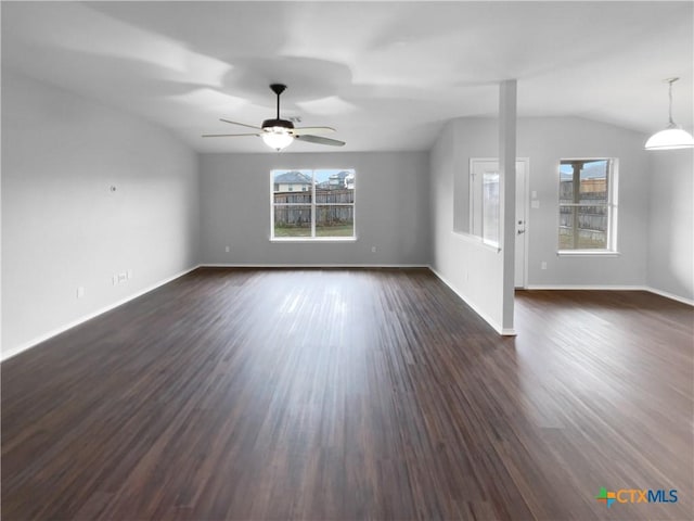 unfurnished living room with dark hardwood / wood-style floors, vaulted ceiling, plenty of natural light, and ceiling fan