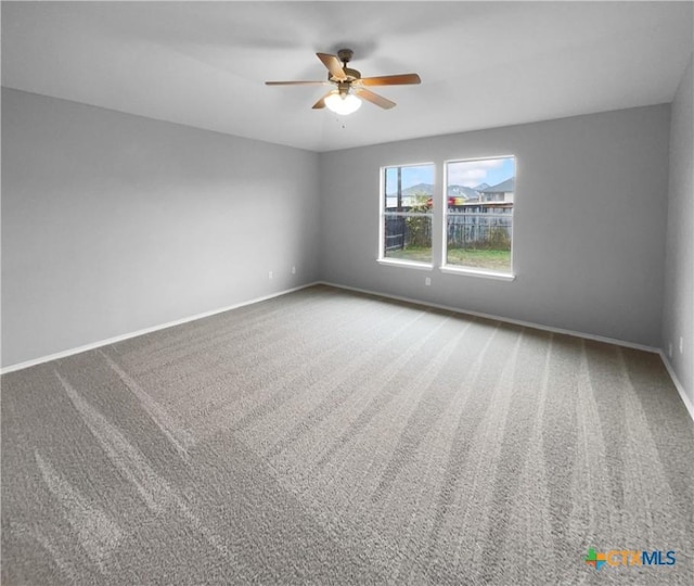 unfurnished room with carpet flooring and ceiling fan