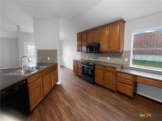 kitchen with dark hardwood / wood-style flooring, sink, black appliances, and plenty of natural light