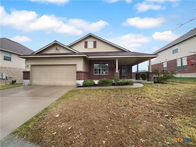 view of front of property with a front yard and a garage