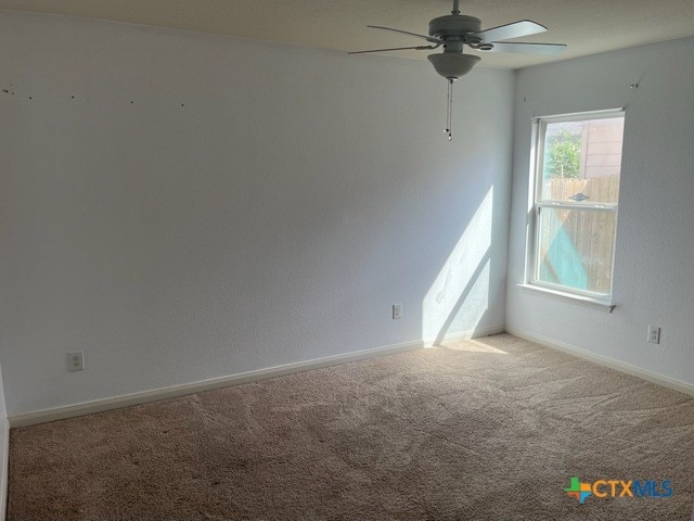 1421 Breanna Ln, Kyle, TX 78640 - unfurnished room featuring carpet floors, a ceiling fan, and baseboards