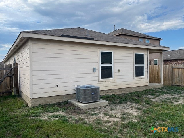 1421 Breanna Ln, Kyle, TX 78640 - back of house featuring a fenced backyard and central air condition unit