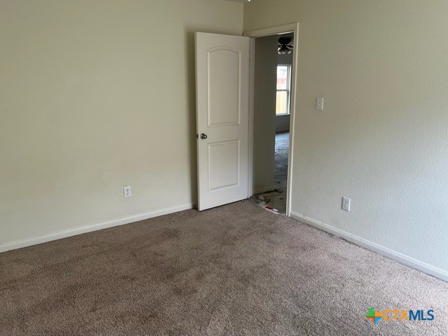 1421 Breanna Ln, Kyle, TX 78640 - unfurnished room featuring carpet flooring and baseboards