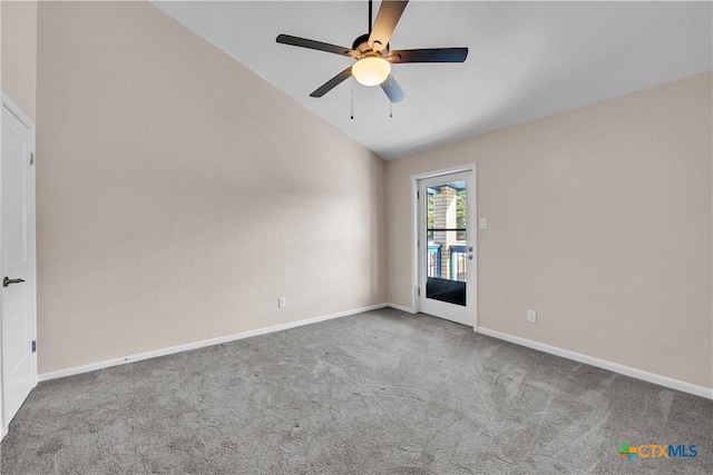 carpeted empty room featuring lofted ceiling, ceiling fan, and baseboards