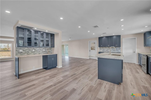 kitchen with recessed lighting, stainless steel electric range oven, a sink, and light wood-style flooring