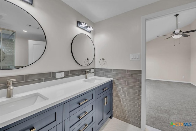 bathroom with visible vents, a sink, tile walls, and double vanity