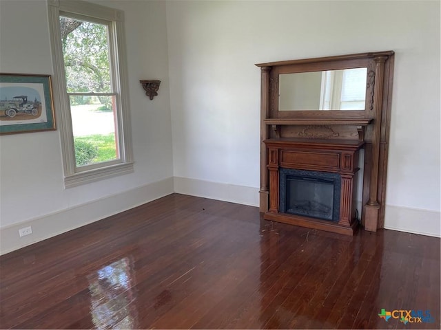 unfurnished living room featuring dark hardwood / wood-style floors