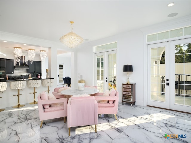 dining room with french doors, a notable chandelier, and marble finish floor