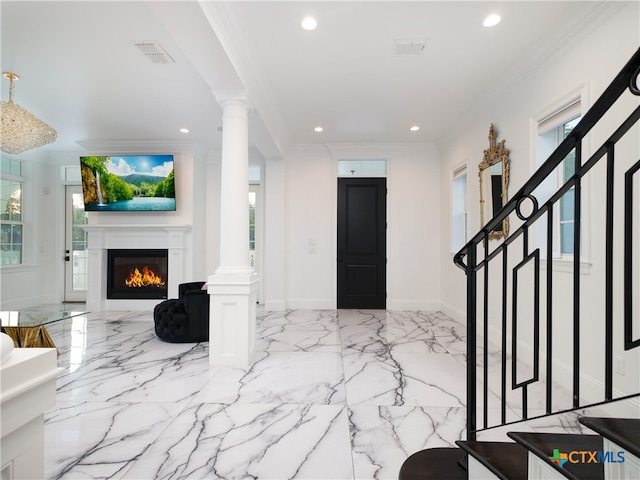 entryway featuring visible vents, stairs, ornate columns, and ornamental molding