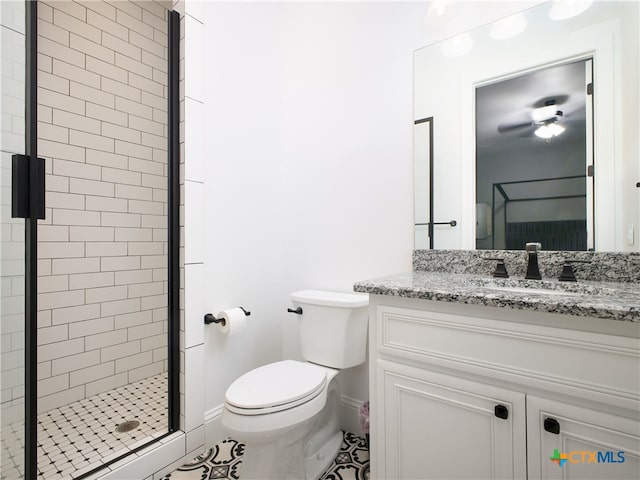 full bathroom featuring a shower stall, toilet, vanity, and baseboards