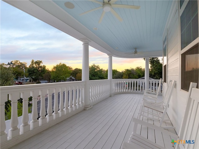 wooden terrace with a ceiling fan