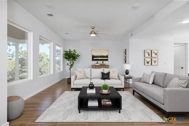107 Onini Ct, Bastrop, TX 78602 - living area featuring ceiling fan, wood finished floors, and baseboards