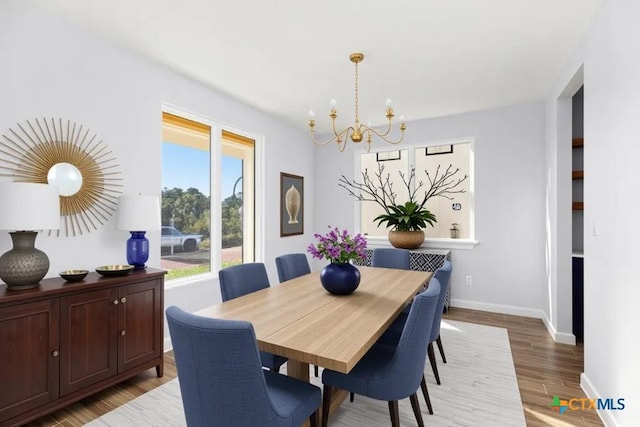 107 Onini Ct, Bastrop, TX 78602 - dining space with a chandelier, baseboards, and light wood-type flooring