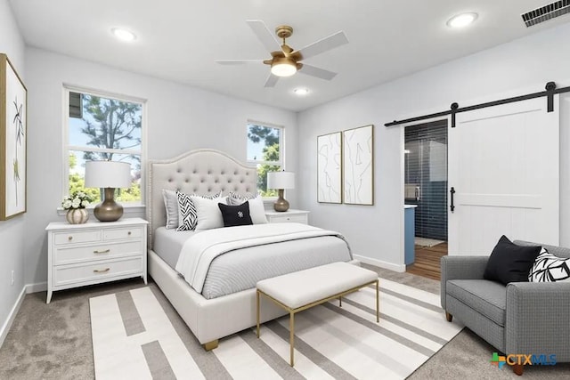 107 Onini Ct, Bastrop, TX 78602 - bedroom featuring a barn door, baseboards, and recessed lighting