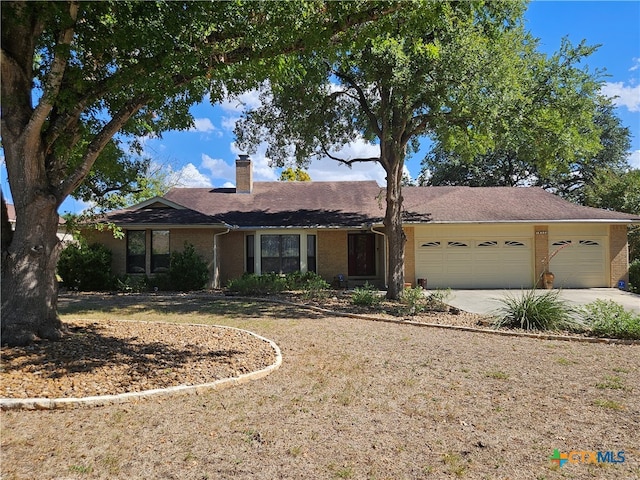 ranch-style house with a garage and a front yard