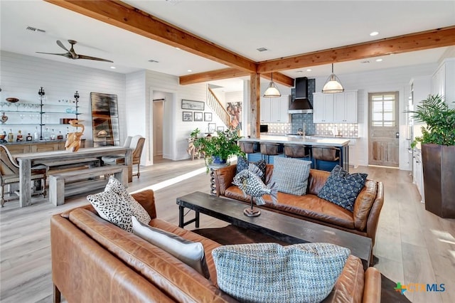 living room featuring ceiling fan and light wood-type flooring