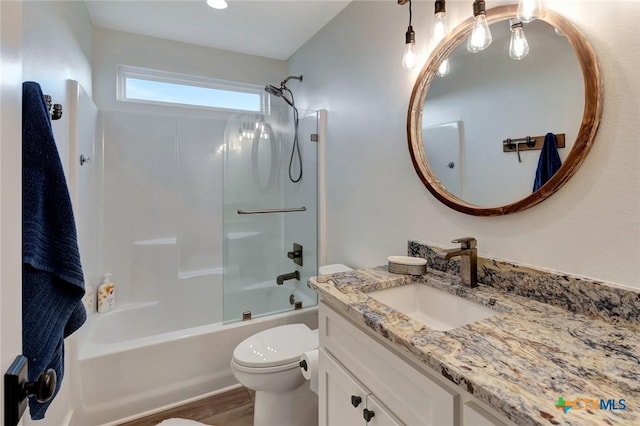 full bathroom featuring hardwood / wood-style flooring, vanity,  shower combination, and toilet