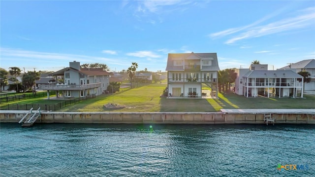 rear view of property featuring a yard and a water view