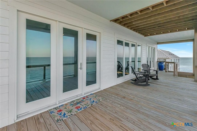 wooden deck featuring a water view