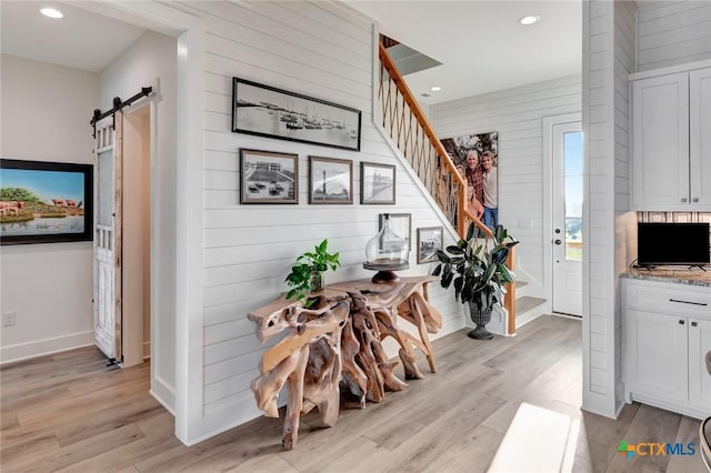 interior space featuring a barn door and light hardwood / wood-style flooring