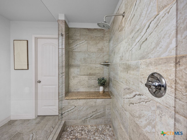 bathroom with tiled shower