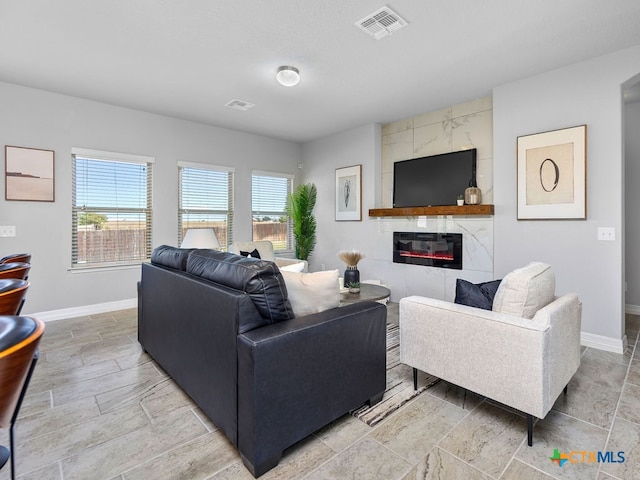 living room with a tile fireplace