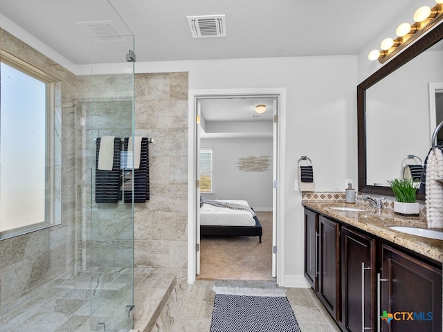 bathroom with a shower with door and vanity