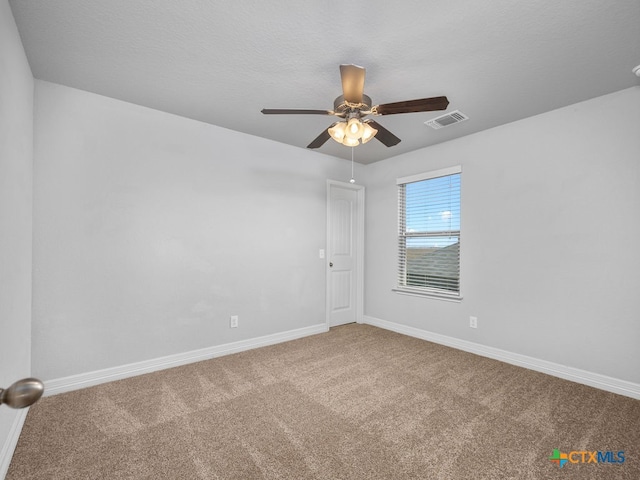 unfurnished room featuring ceiling fan and carpet