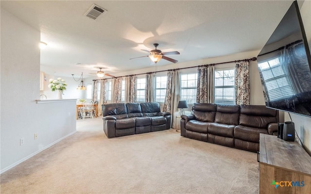 carpeted living room featuring ceiling fan