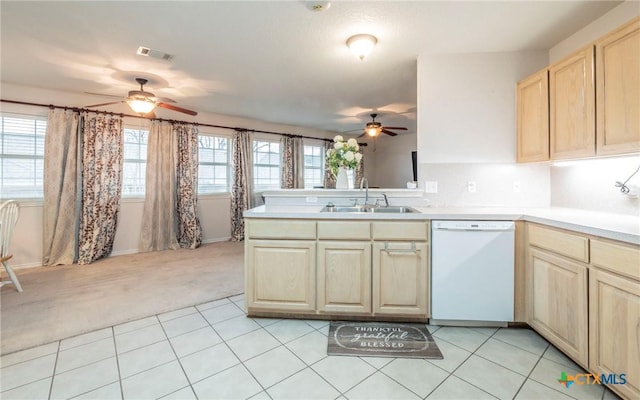 kitchen with light colored carpet, dishwasher, kitchen peninsula, sink, and light brown cabinets