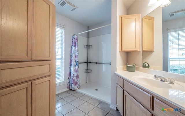 bathroom with tile patterned flooring, vanity, and a shower with curtain