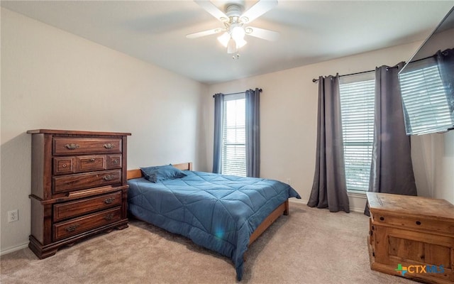 bedroom with ceiling fan and light colored carpet