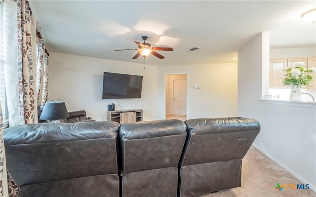 living room featuring ceiling fan and light colored carpet