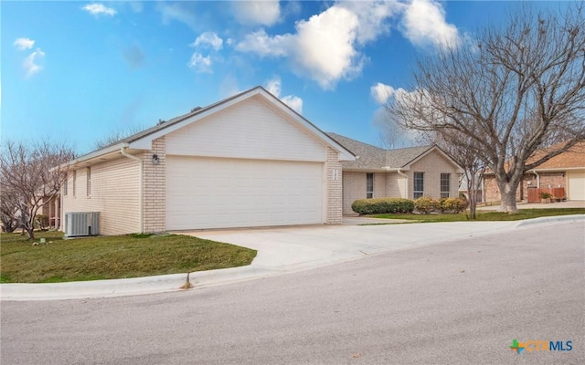 ranch-style home with a front lawn, a garage, and central air condition unit