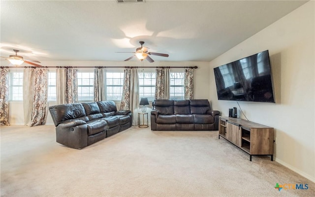 carpeted living room featuring ceiling fan