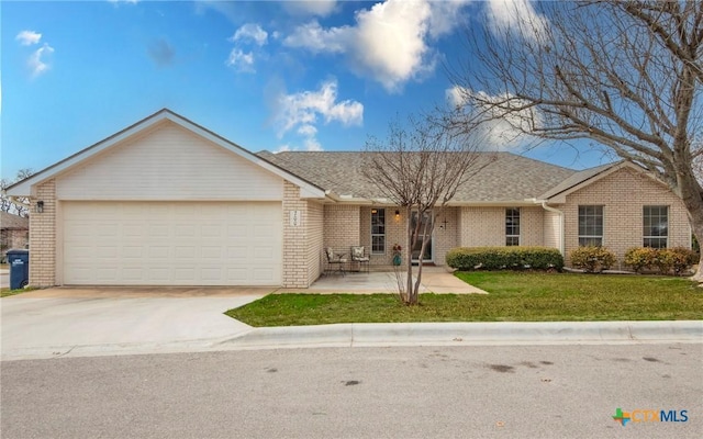 single story home featuring a garage and a front yard