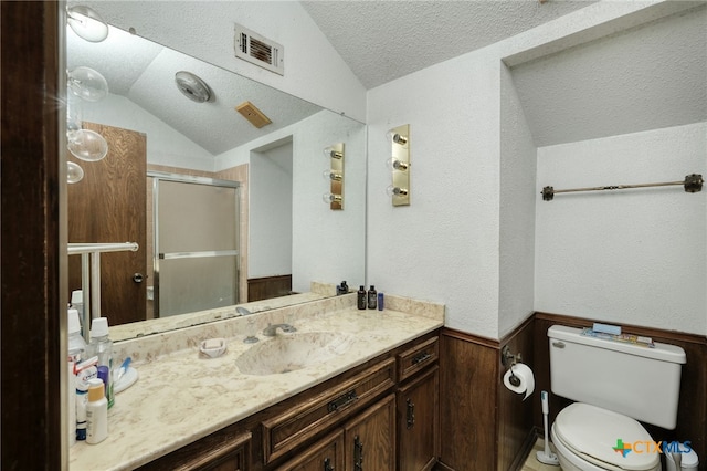 1104 Saint Williams Ave, Round Rock, TX 78681 - bathroom with a textured ceiling, a shower stall, vanity, vaulted ceiling, and toilet