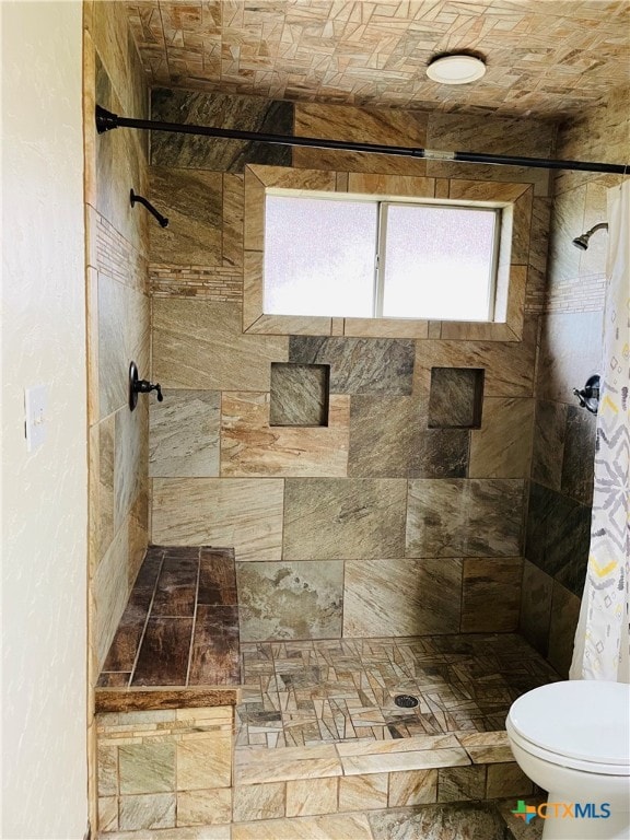 bathroom featuring toilet and a shower with curtain