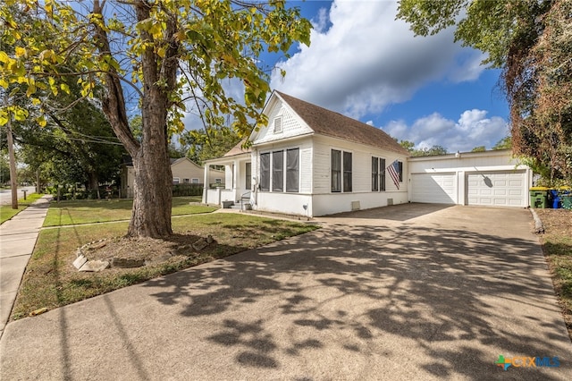 view of front of home with a front yard and a garage