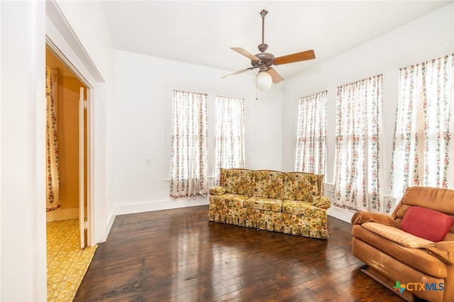 sitting room featuring dark wood-type flooring and ceiling fan