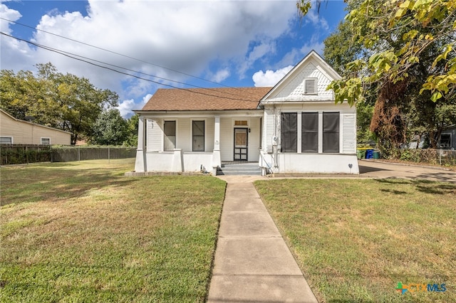 bungalow-style home with a front lawn and a porch