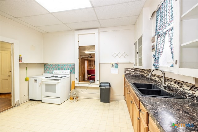 kitchen with a paneled ceiling, sink, tasteful backsplash, and white range with electric cooktop