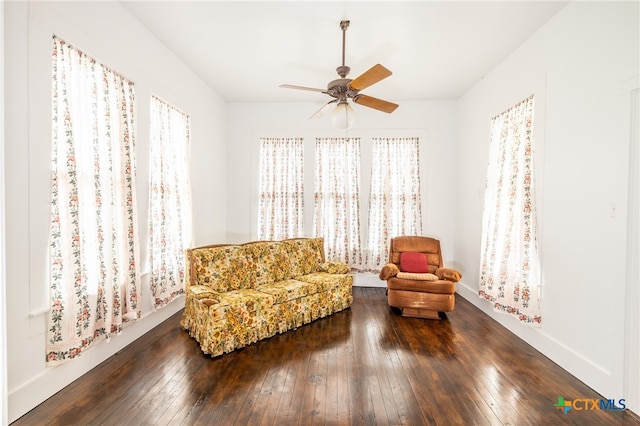 sitting room featuring dark wood-type flooring and ceiling fan