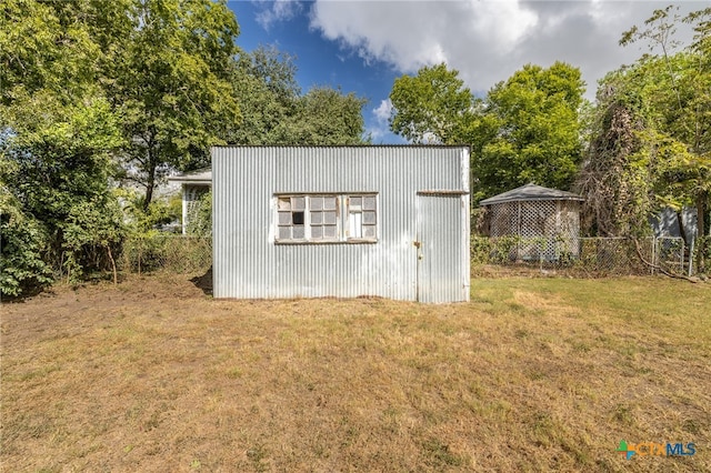 view of outbuilding with a lawn