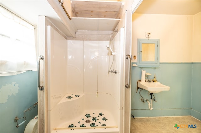 bathroom featuring tile patterned flooring and a shower