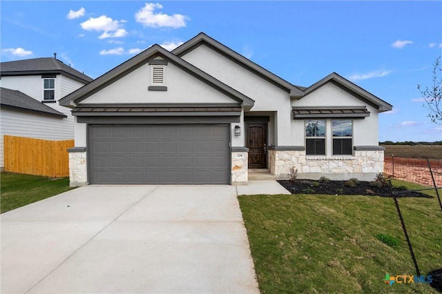 view of front of property featuring a garage and a front yard