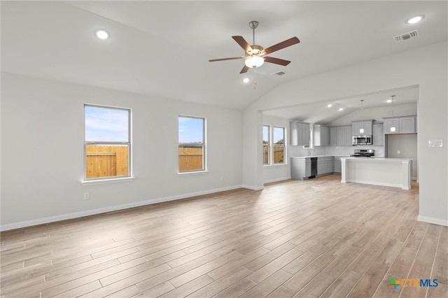 unfurnished living room with ceiling fan, lofted ceiling, and light hardwood / wood-style flooring