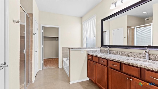 647 Ridgeglen Dr, New Braunfels, TX 78130 - bathroom with a stall shower, double vanity, a walk in closet, a garden tub, and tile patterned flooring