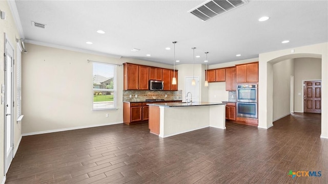 647 Ridgeglen Dr, New Braunfels, TX 78130 - kitchen featuring appliances with stainless steel finishes, dark countertops, backsplash, dark wood-style floors, and brown cabinetry